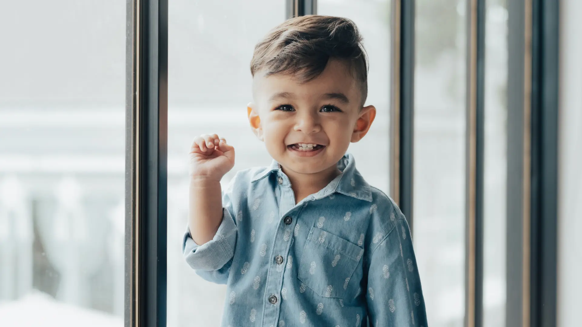 Happy toddler beside a window
